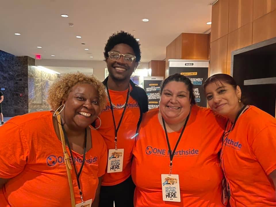 ebony, caleb, nellie and gris in orange shirts and organizing revival name tags