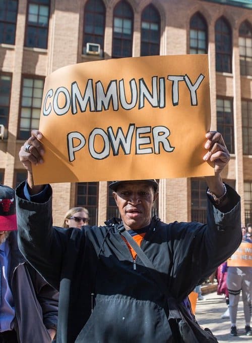 Derrick with Community power sign