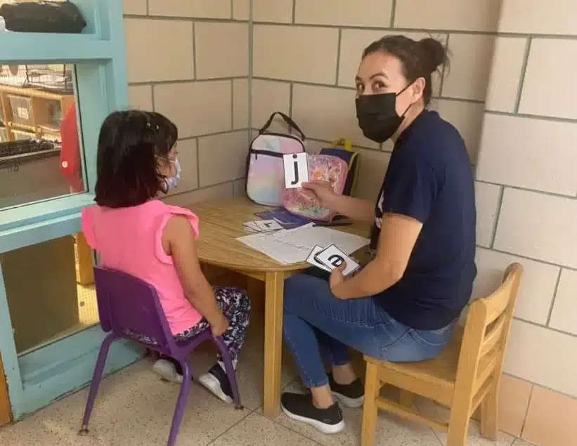 a parent sitting with a student