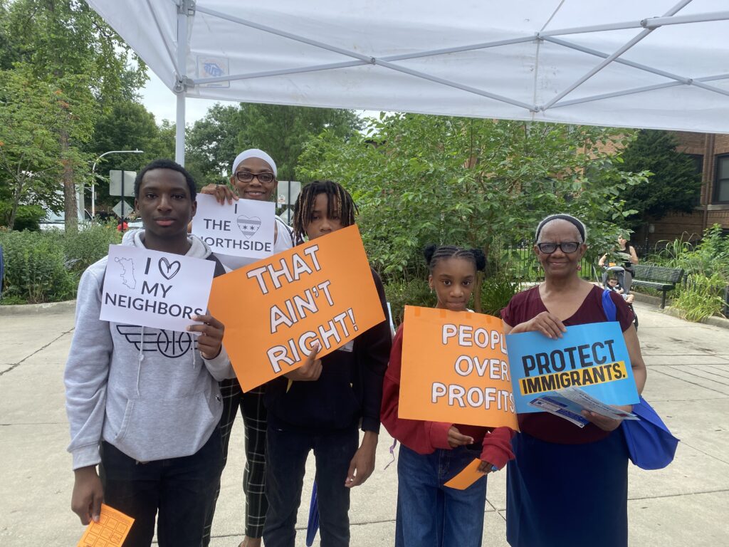 family holding signs saying i love my neighbors and protect immigrants