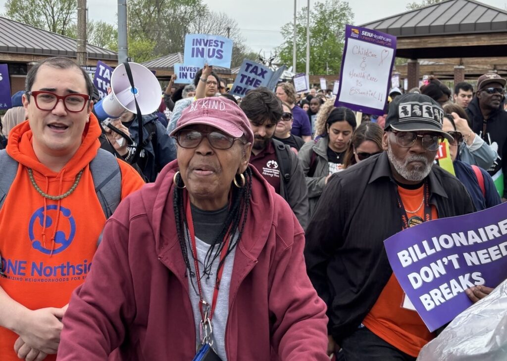 large group marching in springfield to tax the rich